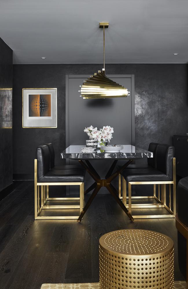 Textured surfaces such as a stone dining table and splashback are teamed with a ‘70s-style brass light fitting to give the kitchen and dining area a stylish but welcoming feel.