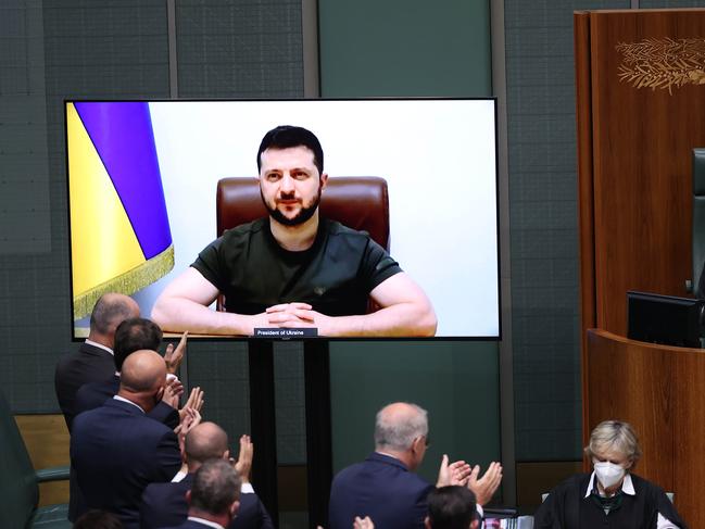 A standing ovation for Volodymyr Zelenskyy, President of Ukraine, for his address to the Australian Parliament via a video link, on a large screen on the floor of the House of Representatives chamber. Picture: NCA NewsWire / Gary Ramage