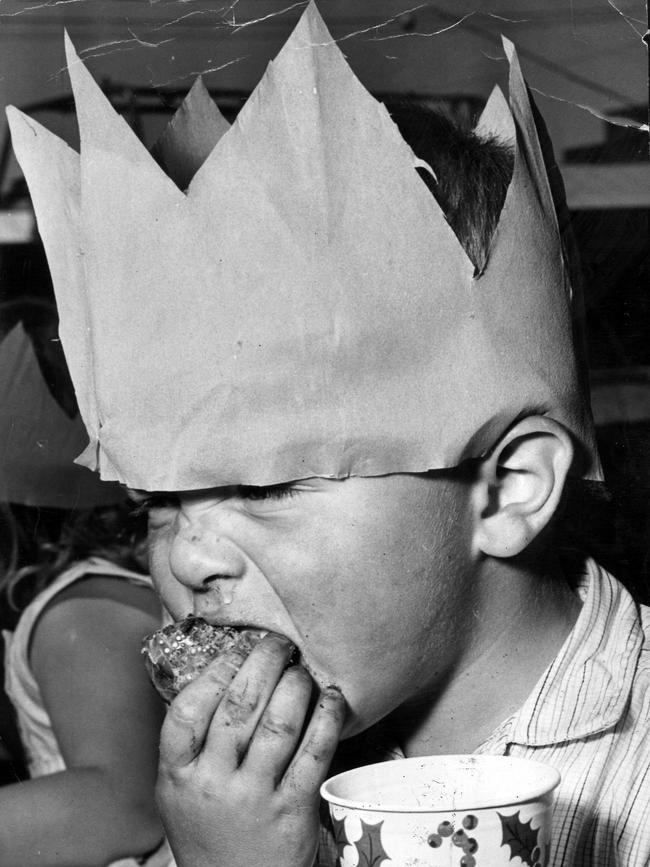 A small child eating Christmas lunch in 1965.