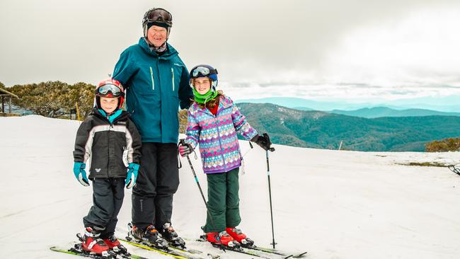 Melbourne grandad Graeme Sinclair takes his eldest grandkids Savannah and Tyler to the snow every year. Here they are at Mt Buller. Picture: Sean Lander