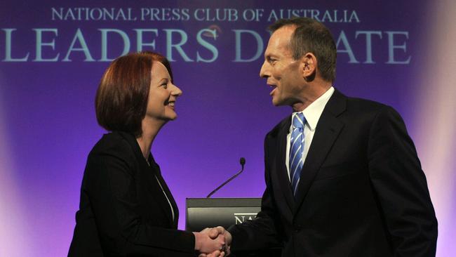 Labor prime minister Julia Gillard and conservative opposition leader Tony Abbott shake hands before leaders' debate at the National Press Club in Canberra in 2010. Picture: Alan Porritt/AFP