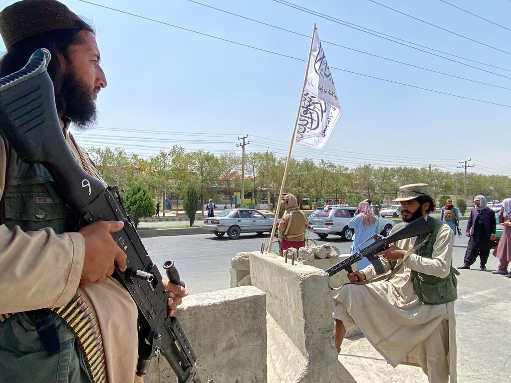 Taliban fighters stand guard at an entrance gate outside the Interior Ministry in Kabul on August 17. Picture: AFP