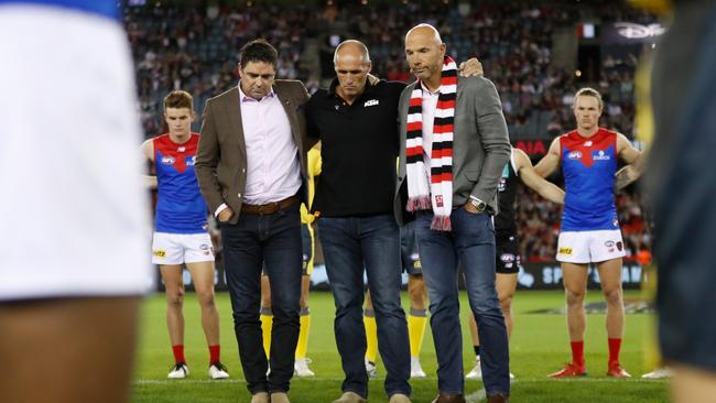 Garry Lyon, Tony Lockett and Stewart Loewe pause to remember Danny Frawley during the 2021 AFL Round 02 match between the St Kilda Saints and the Melbourne Demons at Marvel Stadium on March 27, 2021 in Melbourne, Australia. (Photo by Michael Willson/AFL Photos)