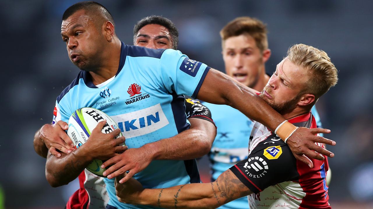 Kurtley Beale of the Waratahs is tackled by Tyrone Green of the Lions.