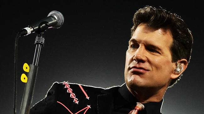 MELBOURNE, AUSTRALIA - MARCH 13: Chris Isaak performs at the half time break of the round one NRL match between the Melbourne Storm and the St George Illawarra Dragons at Olympic Park on March 13, 2009 in Melbourne, Australia. (Photo by Mark Dadswell/Getty Images)