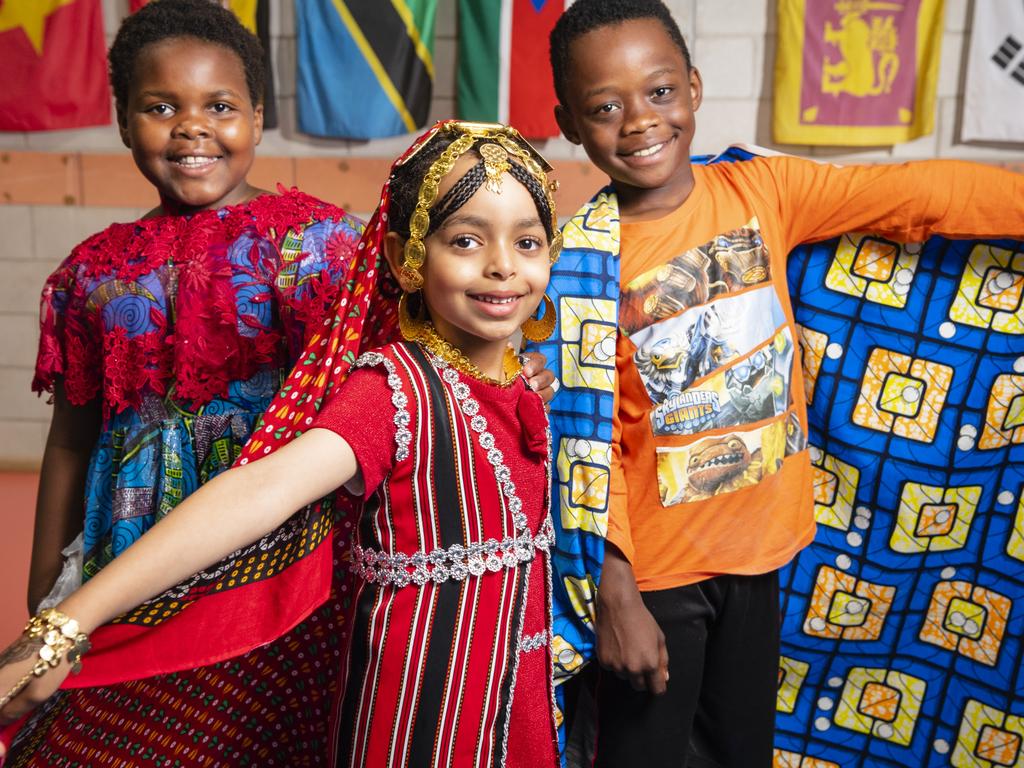 Representing their culture are (from left) Faith Bahati, Chum Ibrahim and Dieume Antoine at Harmony Day celebrations at Darling Heights State School. Picture: Kevin Farmer