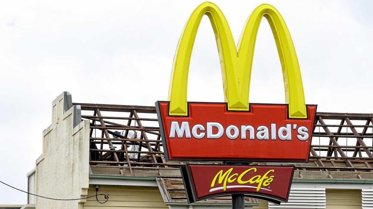 OUT WITH THE OLD: Workers remove the roof from the old firemans hall in Limestone Street in preparation for its demolition to extend the McDonald&#39;s carpark. Picture: Rob Williams