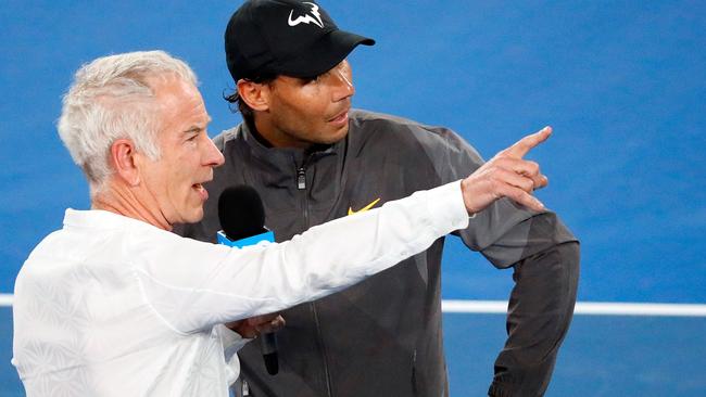 Spain's Rafael Nadal talks to former US tennis player John McEnroe (L) after the men's singles match against Australia's Matthew Ebden on day three of the Australian Open tennis tournament in Melbourne on January 16, 2019. (Photo by DAVID GRAY / AFP) / -- IMAGE RESTRICTED TO EDITORIAL USE - STRICTLY NO COMMERCIAL USE --