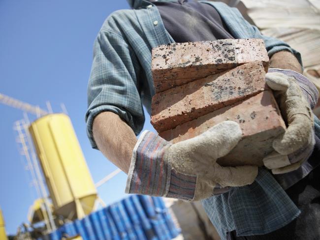 Mid Section Shot of a Builder Holding Bricks - Townsville Bulletin use only - Careerone generic