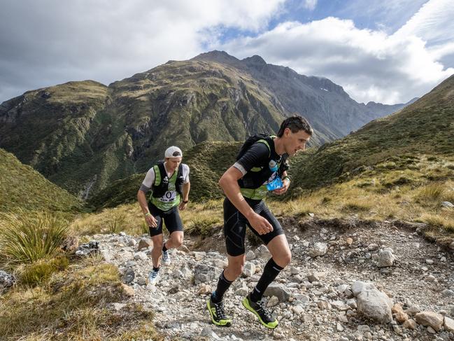 Alex Hunt (right) crossing the highest point of the course at the summit of Goat Pass during the 2024 race. Photo: Iain McGregor