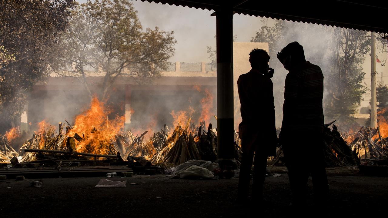 Funeral pyres are burning across New Delhi as India becomes the world’s latest COVID hotspot. (Photo by Anindito Mukherjee/Getty Images)
