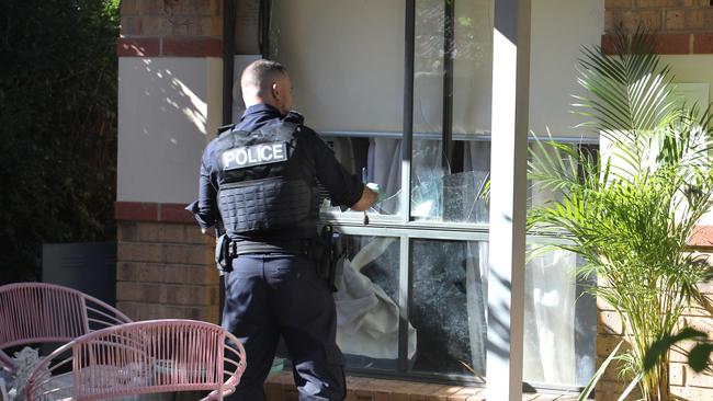 A woman is in hospital after she was attacked by a machete during a home invasion. Police dust for fingerprints. Picture: Dean Martin