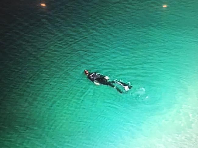 A police diver on Lake McKenzie. Picture: Nine News