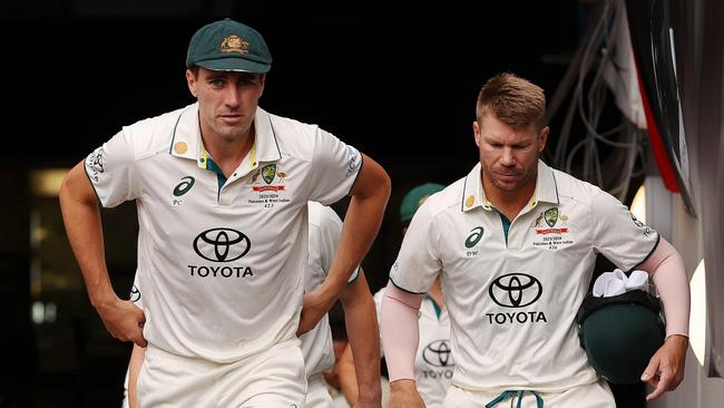 MELBOURNE, AUSTRALIA - DECEMBER 26: Pat Cummins of Australia walks out onto the field alongside teammate David Warner prior to day one of the Second Test Match between Australia and Pakistan at Melbourne Cricket Ground on December 26, 2023 in Melbourne, Australia. (Photo by Robert Cianflone/Getty Images)