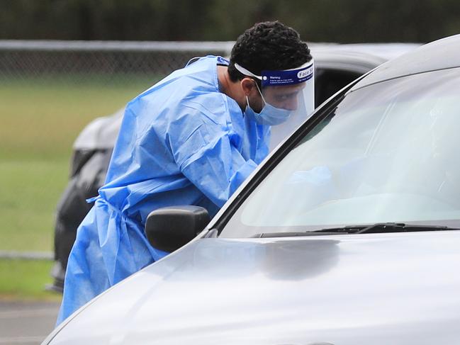 CURRUMBIN , AUSTRALIA - NewsWire Photos March 31, 2021: QML Pathology staff test Gold Coast locals who have to wait hours to be tested for Covid-19 at the Currumbin Eagles Rugby League Club which has turned into a Pop Up Testing.Picture: NCA NewsWire / Scott Powick