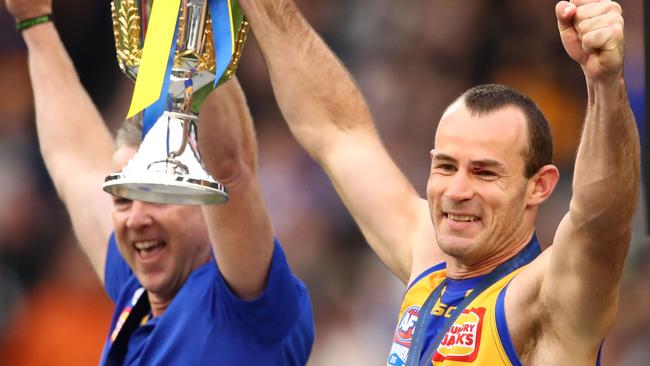 Shannon Hurn of the Eagles and Adam Simpson, coach of the Eagles hold the premiership cup aloft after winning the 2018 AFL Grand Final. Picture: Scott Barbour/AFL Media/Getty Images)