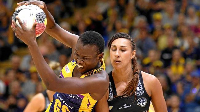 Peace Proscovia of the Lightning catches the ball ahead of Magpies player Geva Mentor. Picture: Bradley Kanaris