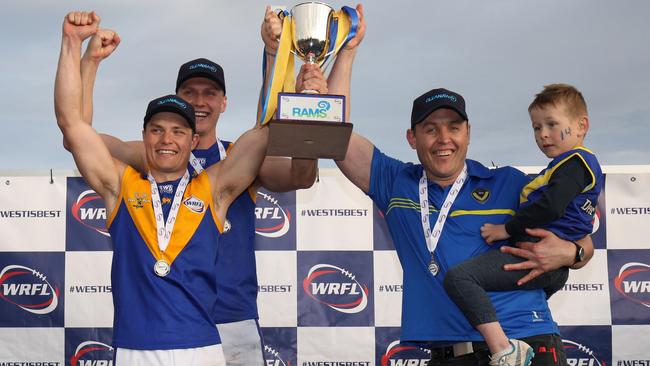 Deer Park co-captains Jake McKenzie and Jack Purton-Smith and coach Marc Bullen hoist the silverware in 2019. Picture: Local Legends Photography