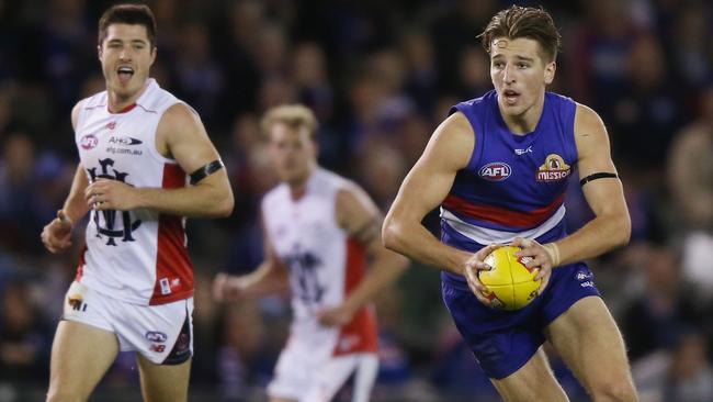 Melbourne players watch Marcus Bontempelli run amok.