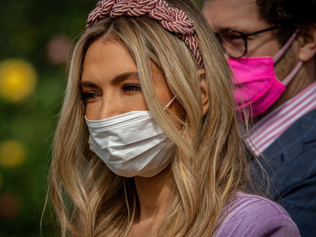 She teamed her plunging dress with a compulsory face mask. Picture: Darrian Traynor/Getty Images