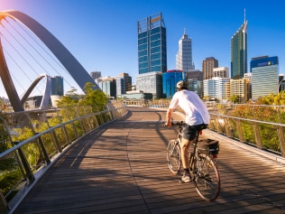 A man cycling on an elizabeth bridge in Perth city, western, Austrakia, this image can use for bike, sport, relax, healthy concept