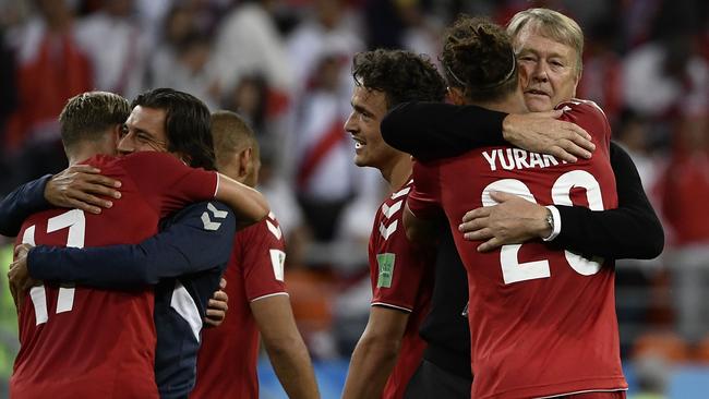 Yussuf Poulsen gets a hug from his coach Age Hareide after scoring the winner.