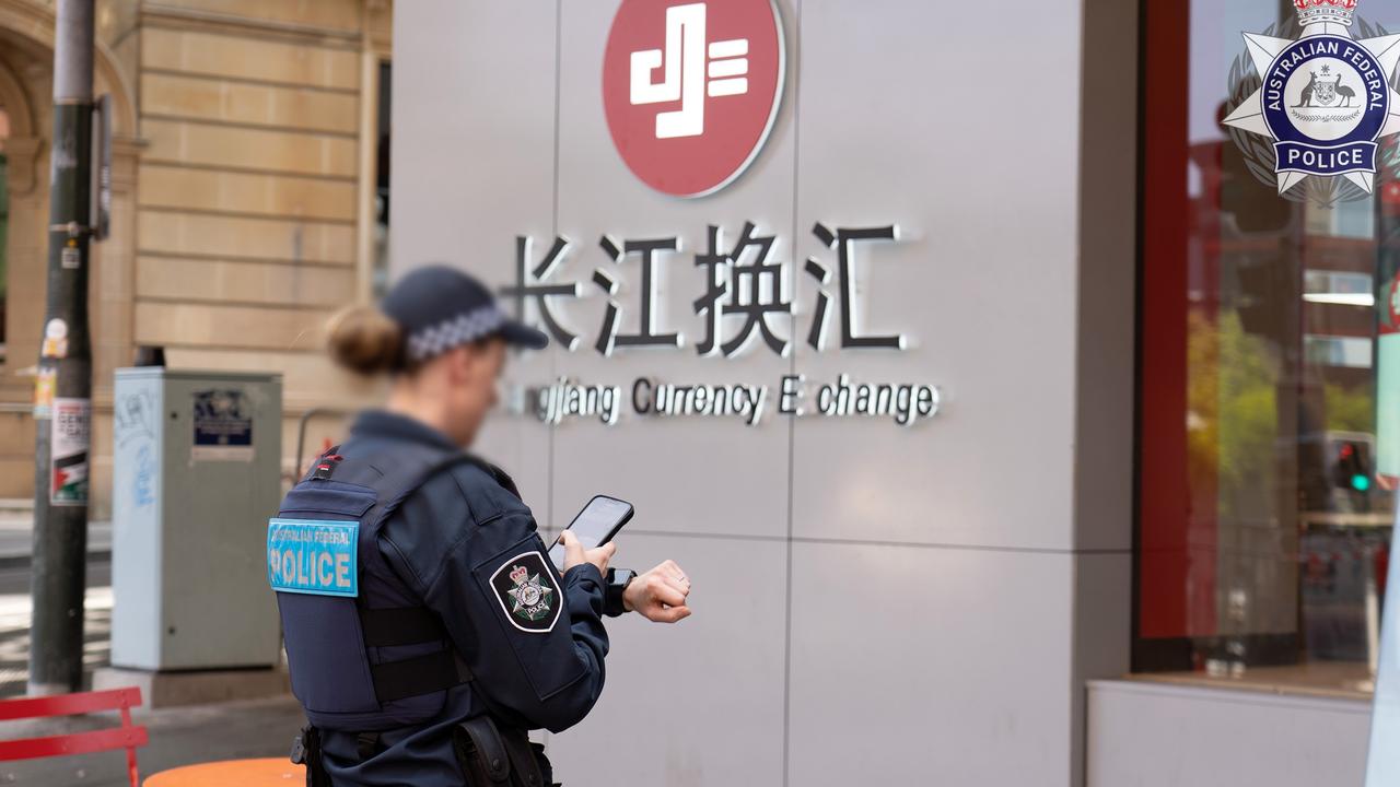 Police at the Sydney storefront of Changjiang Currency Exchange.