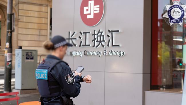 Police at the Sydney storefront of Changjiang Currency Exchange.