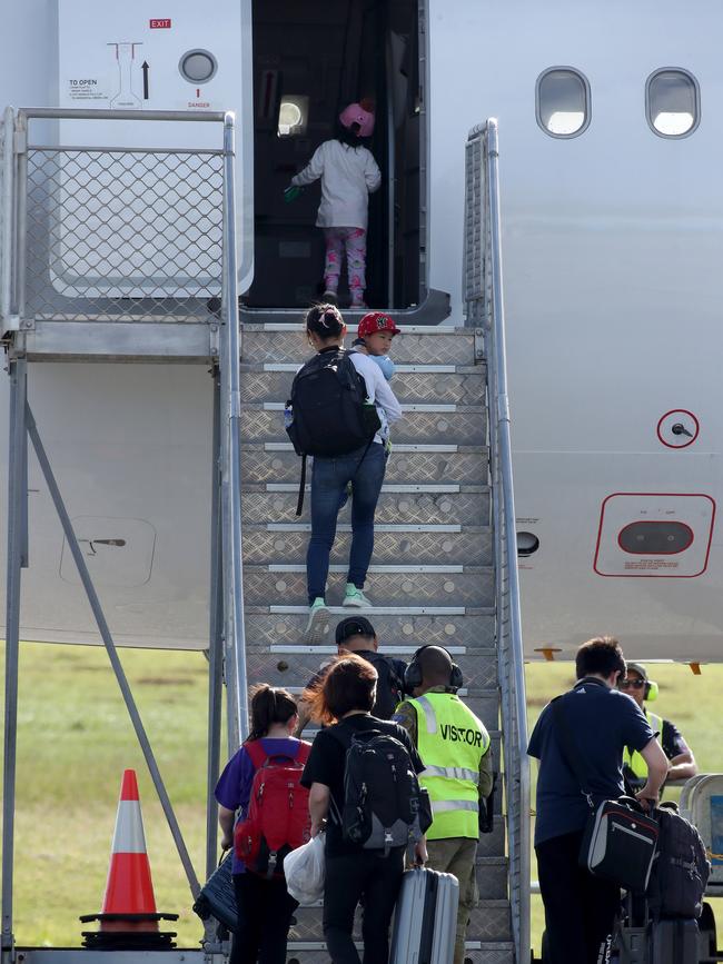 Wuhan evacuees board a plane to leave Christmas Island. Picture: Colin Murty