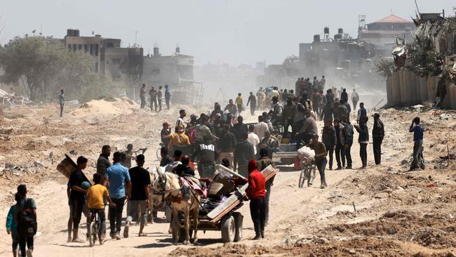 Palestinians who had taken refuge in Rafah return to Khan Younis after Israel pulled its ground forces out of the southern Gaza Strip. Picture: AFP.