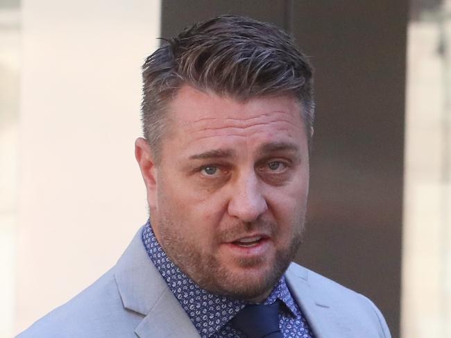 MELBOURNE, AUSTRALIA - NewsWire Photos, MARCH 26, 2024. (ID confirmed-Journo Liam Beatty) . Former AFL star Sam Fisher leaves the County Court of Victoria where he is facing  allegations he was involved in a cross-border drug trafficking operation.   Picture: NCA NewsWire / David Crosling