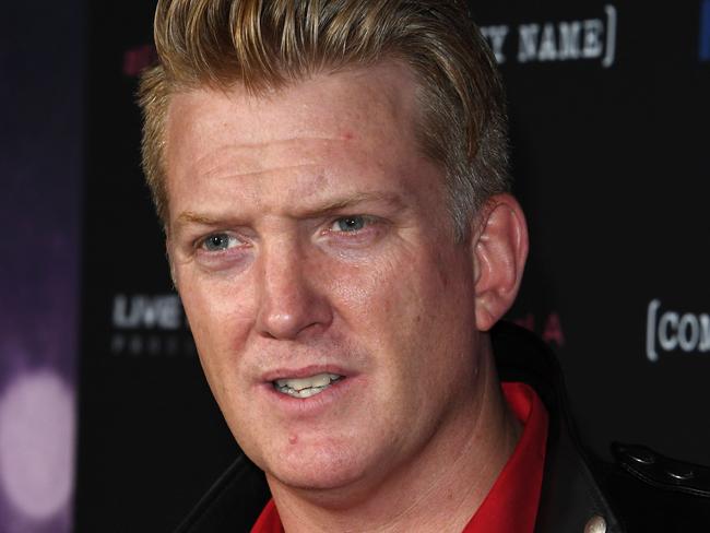 (FILES) This file photo taken on February 2, 2017 shows "Queens of the Stone Age" frontman Josh Homme attending the premiere of 'Eagles of Death Metal' at the Avalon Theatre in Los Angeles, California. Homme apologized on December 10, 2017, as he came under fire for kicking a press photographer, who said she spent the night in the hospital. The rock guitarist and vocalist was playing Saturday in Los Angeles at an annual holiday festival of radio station KROQ when video shows him slamming his foot into the face of a photographer in the pit next to the stage.  / AFP PHOTO / Mark RALSTON