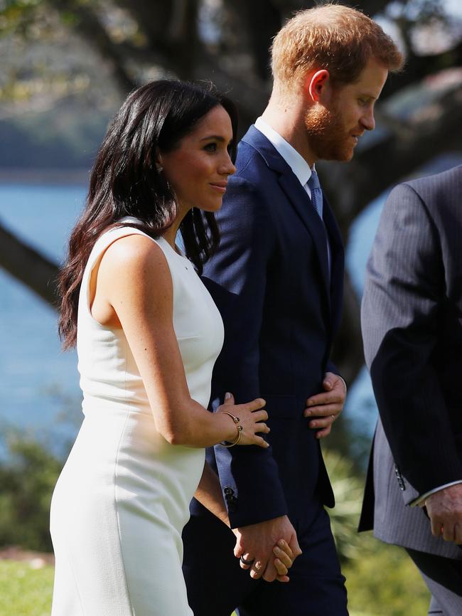 Meghan shows a hint of her baby bump as she tours Sydney with her husband Prince Harry. Picture: Phil Noble/Getty Images