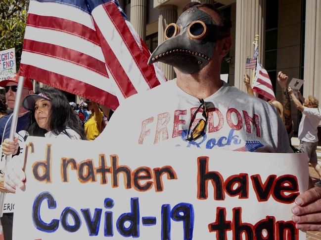 A demonstrator wearing a plague doctor mask protests during a rally to re-open California and against Stay-At-Home directives on May 1, 2020 in San Diego, California. - Rallies have been held at several state capitols across the country as protesters express their deep frustration with the stay-at-home orders that are meant to stem the spread of the novel coronavirus. (Photo by Sandy Huffaker / AFP)