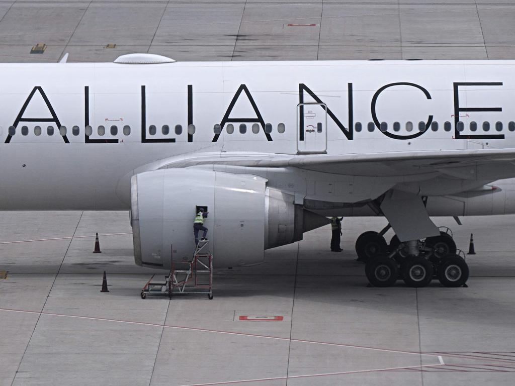 A worker looks into one of the engines of the Singapore Airlines Boeing 777-300ER aeroplane. Picture: AFP