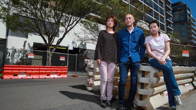 Upset and desperate residents of Mascot Towers, Kasumi Kitano with her husband Thomas Deakin and Angel Chen, outside their building in Mascot. Picture:Justin Lloyd