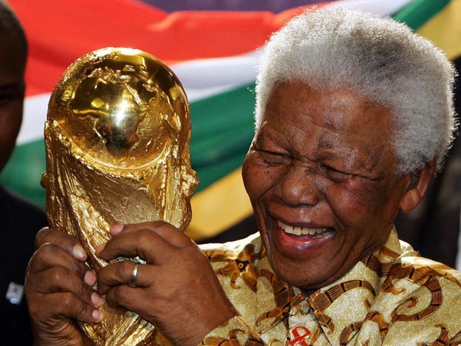 South Africa’s former president Nelson Mandela holds the Jules Rimet World Cup in 2004.