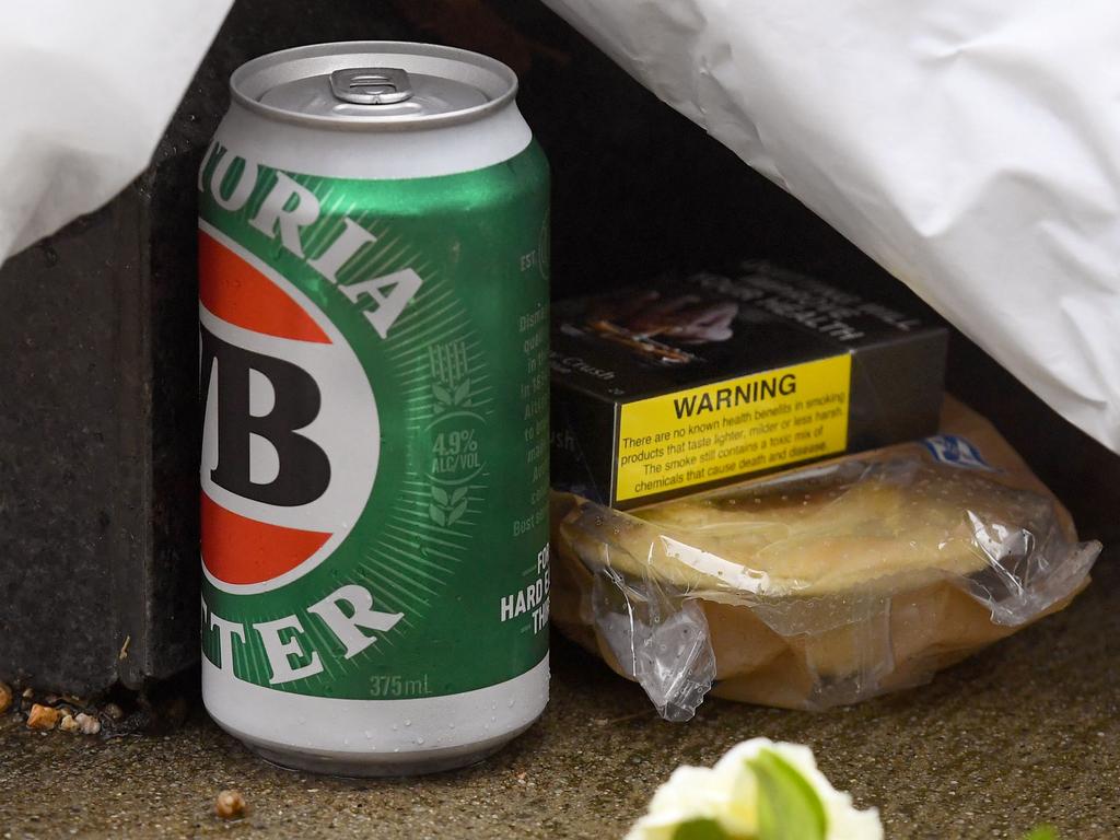 A can of Victoria Bitter (VB) beer, a packet of cigarettes and a meat pie placed beneath Warne’s statute outside the MCG. Picture: William West