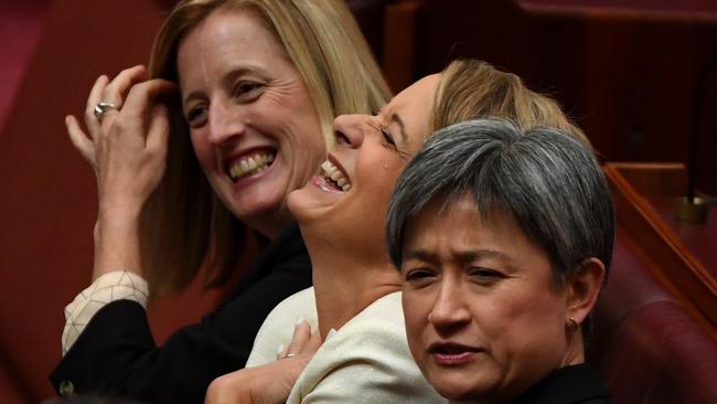 Senator Katy Gallagher, left, Senator Kristina Keneally, centre, and Senator Penny Wong, right, in the Senate chamber.