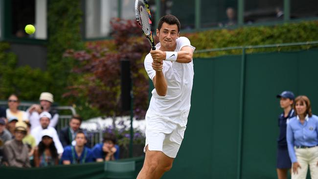 Australia's Bernard Tomic returns against Germany's Mischa Zverev during their men's singles first round match at Wimbledon. Picture: Justin Tallis/AFP