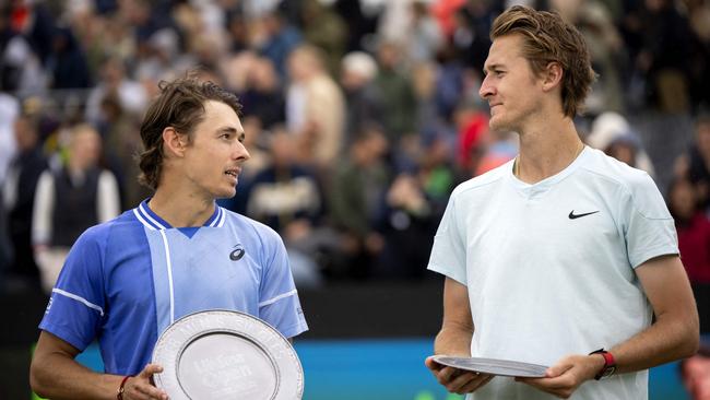 Asutralia's Alex de Minaur (L) celebrates with the trophy after winning against US' Sebastien Korda after their men's singles final match of Rosmalen Grass Court Championships tennis tournament in Rosmalen, near Hertogenbosch, on June 16, 2024. (Photo by Sander Koning / ANP / AFP) / Netherlands OUT