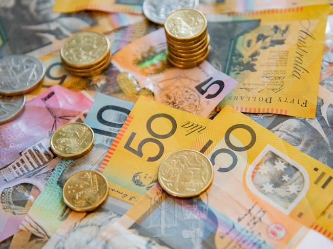 Australian notes and coins spilled out on a table