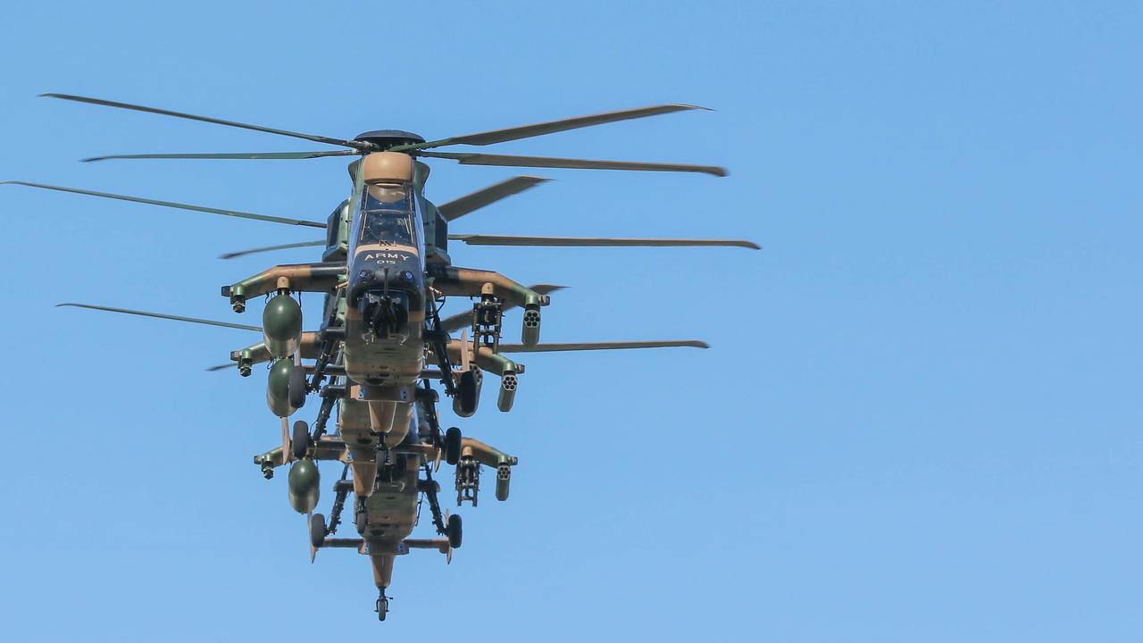 Attack Helicopters conduct a flypast during the march on Darwin's Knuckey St commemorating ANZAC Day 2021. Picture Glenn Campbell