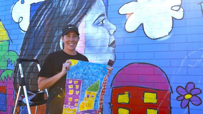 Artist Polly Johnstone – known as Miss Polly – kicks off the first Palmerston Street Art Festival in 2024. Her mural is based on a painting she did as a child, and includes a portrait of her younger self and an amalgamation of her two sons. Picture: Sierra Haigh