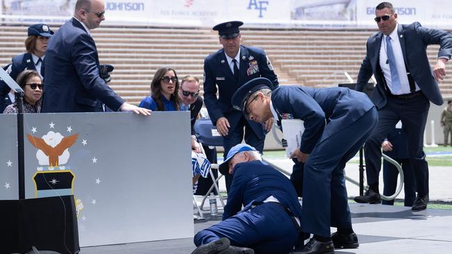 Mr Biden is helped up after falling during the graduation ceremony at the United States Air Force Academy in 2023. Picture: AFP