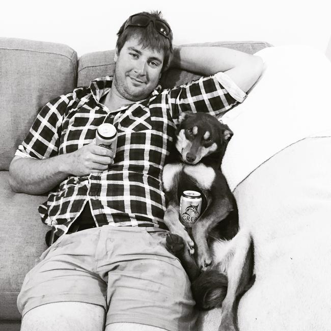 Chloe Smith’s rescue Kelpie Dusty relaxes on the couch with Chloe’s partner Michael. Picture: Chloe Smith