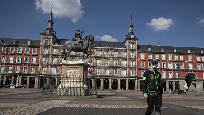 A man wears a protective mask as he walks along Plaza Mayor Square in Madrid. Picture: Getty Images