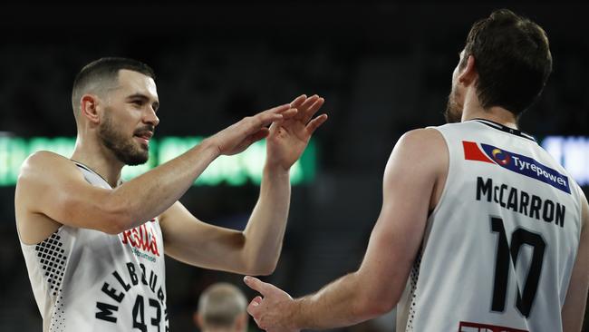 MELBOURNE, AUSTRALIA – MARCH 27: Chris Goulding of United (L) celebrates with Mitch McCarron of United during the round 11 NBL match between Melbourne United and the South East Melbourne Phoenix at John Cain Arena on March 27, 2021 in Melbourne, Australia. (Photo by Daniel Pockett/Getty Images)