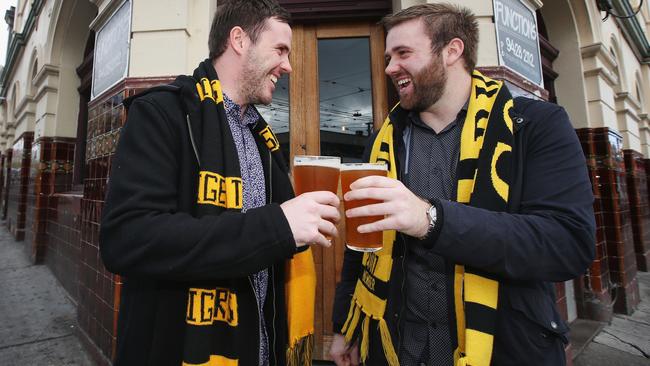 Two mates and Richmond Tigers fans show their support while having a beer at the Swan Hotel. Picture: Michael Dodge, Getty Images.                        <a capiid="f19a952a3f40332c9a5e9604032bffef" class="capi-video">Unreal scenes at the MCG</a>