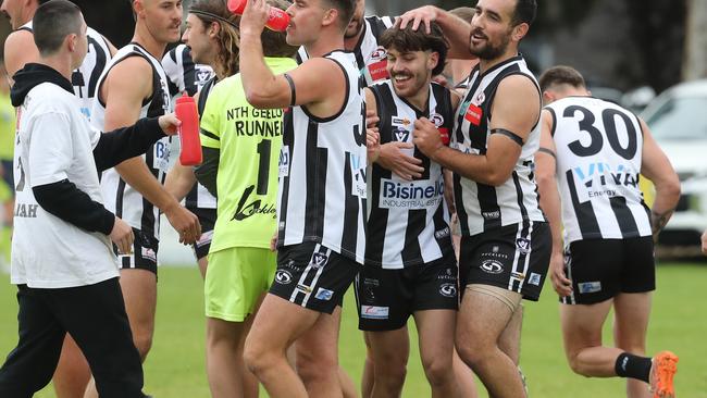 Osca Riccardi is swamped by his North Geelong teammates after kicking a goal on club debut. Picture: Alan Barber